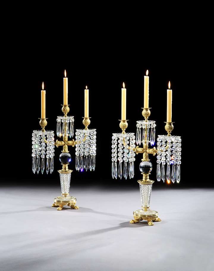 A PAIR OF REGENCY ORMOLU MOUNTED CUT GLASS CANDELABRA